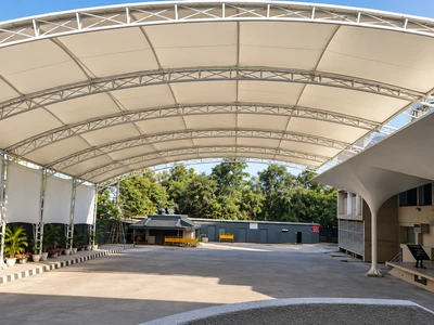 Large span school assembly tensile roof on arched steel trusses at Arwachin Bharti Bhawan School, Vivek Vihar, Delhi