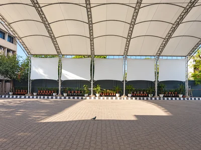 Arched steel trusses and side fabric panels of the school assembly tensile roof at Arwachin Bharti Bhawan School, Delhi