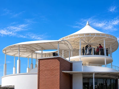 Conical canopy and barrel vault tensile roofs on the hilltop resort building at Chandragiri Hills, Nepal