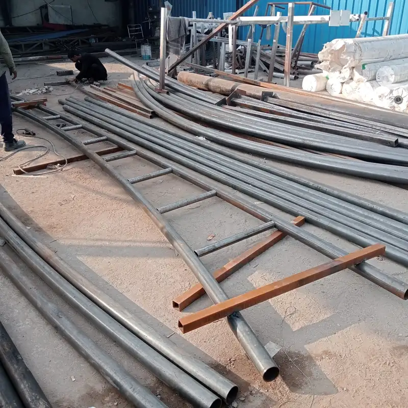 Curved steel tubes and frames being prepared in the ShadeCo India fabrication workshop