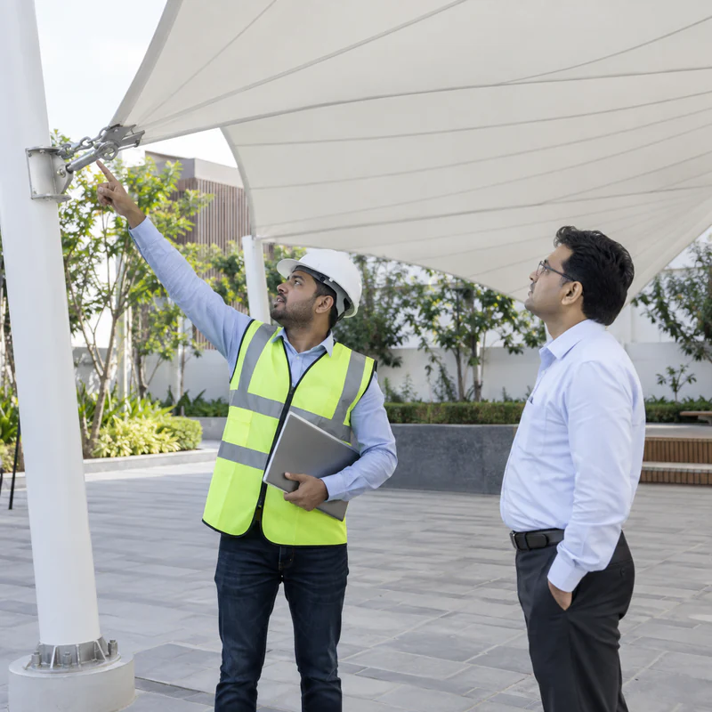 Engineer explaining completed canopy fixings during client handover