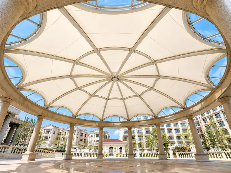 Radial steel framing beneath a circular tensile membrane roof over a rotunda