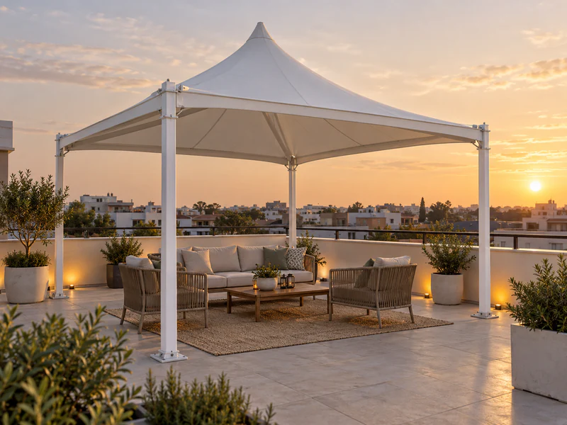 White peaked tensile gazebo with lounge seating on a residential rooftop terrace