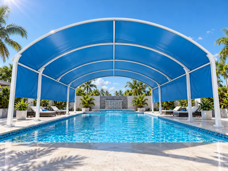 Blue fabric canopy on white steel arches above a swimming pool