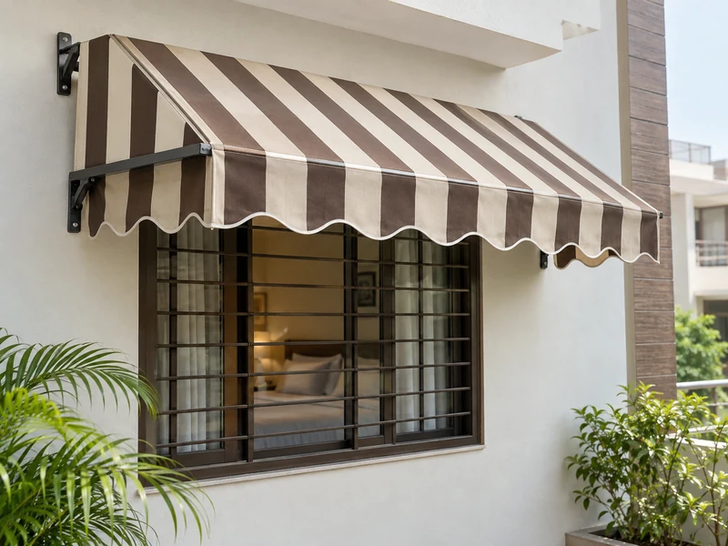 Striped acrylic window awning with a scalloped valance above a bedroom window with a grill