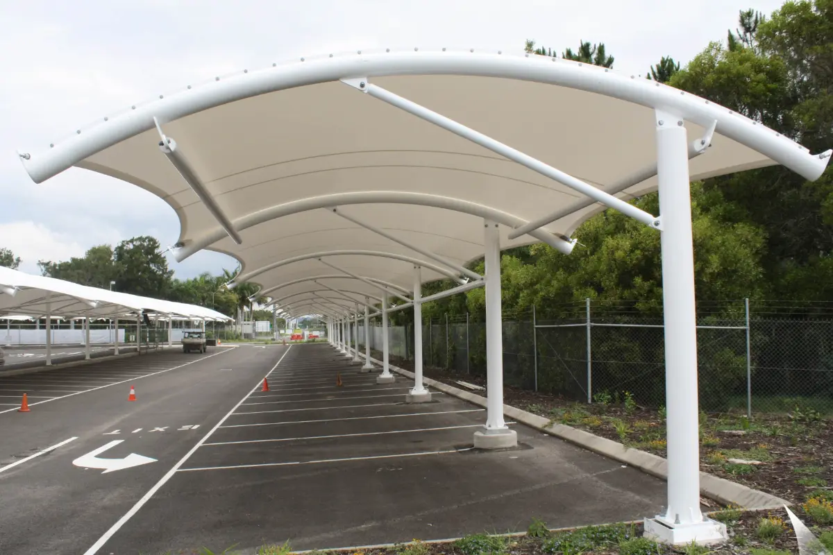 In a parking lot, a tensile canopy is displayed showcasing cantilever car parking shade structures installation
                                                        by Shadeco.