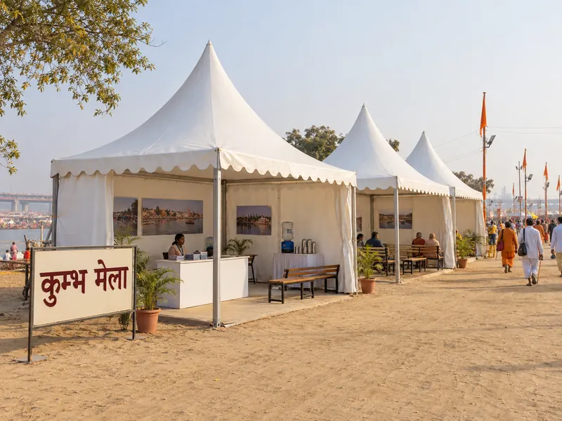 Illustrative Kumbh Mela visitor camp with white pagoda tents and a Hindi festival sign