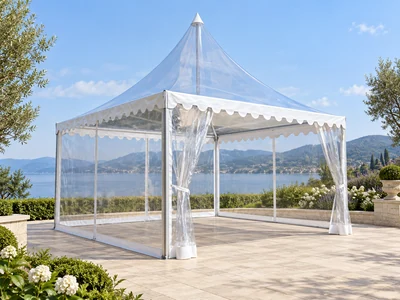 Transparent pagoda tent with clear roof, side panels and white scalloped frill at an outdoor lakeside venue