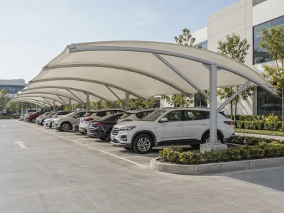 Double-sided fabric canopies shading visitor parking outside office buildings