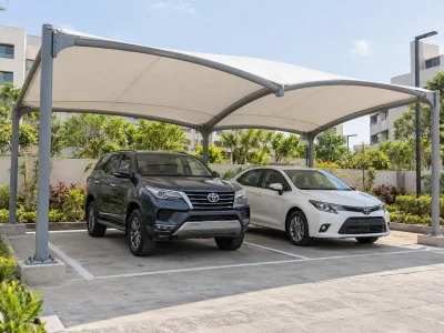 White fabric parking canopy covering two adjacent car bays