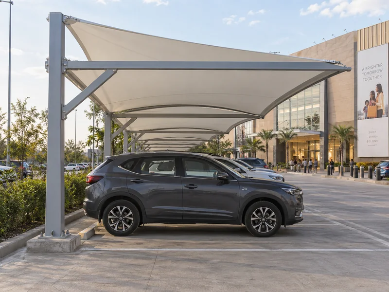 Fabric parking shades in brand colours over customer parking in front of a shopping mall