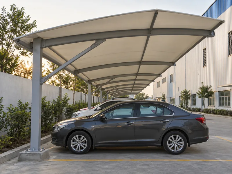 One continuous parking shed covering a long single row of cars along a factory boundary