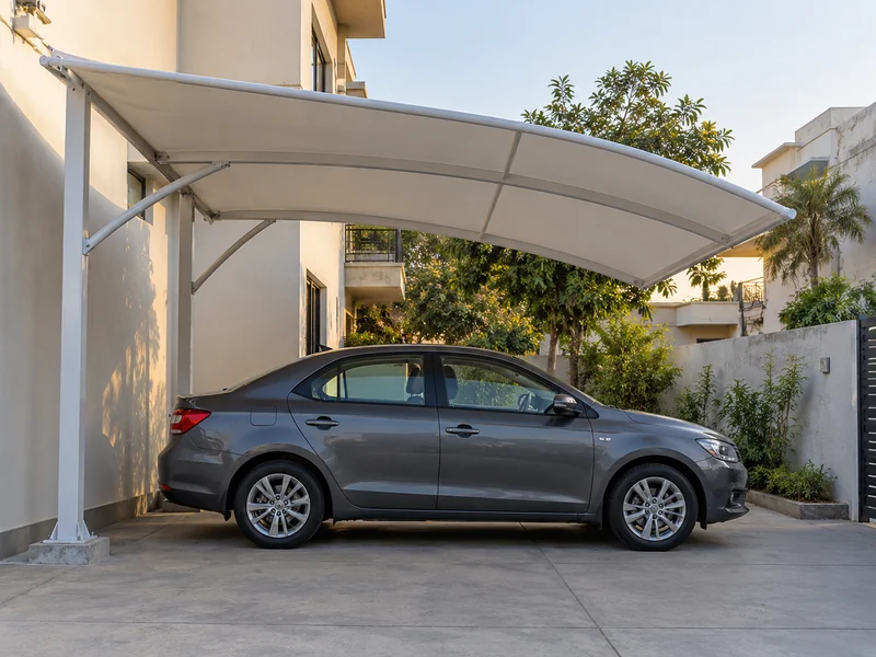 Compact fabric parking shade over one car in a narrow home driveway, with two posts at the back