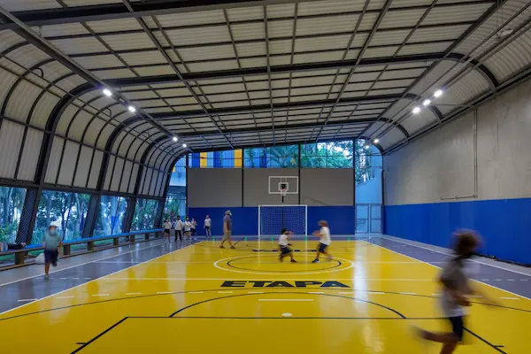 Indoor basketball court with side cover walls showcasing, ShadeCo expertise in prefabricated sports structures in India.