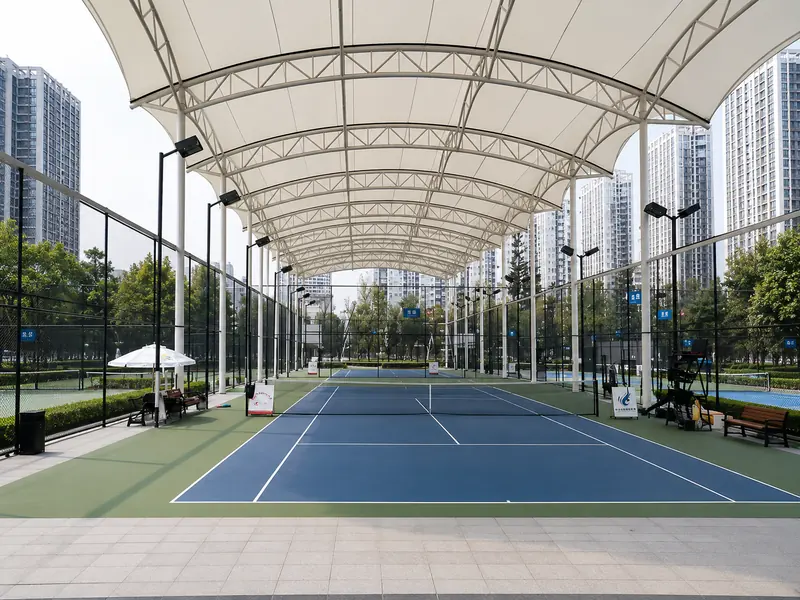 Modern tennis court shade structure with tensile canopy roofing for outdoor sports facilities