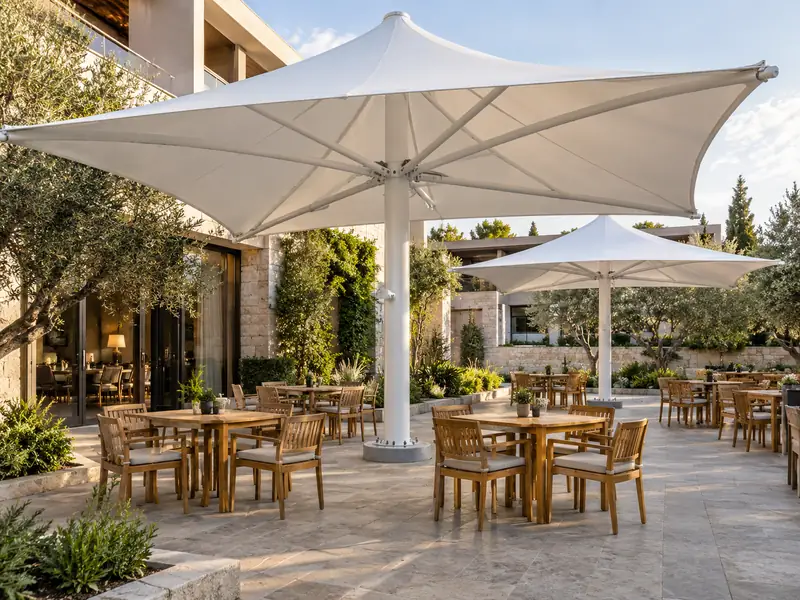 Square white architectural umbrella canopies shading outdoor café tables