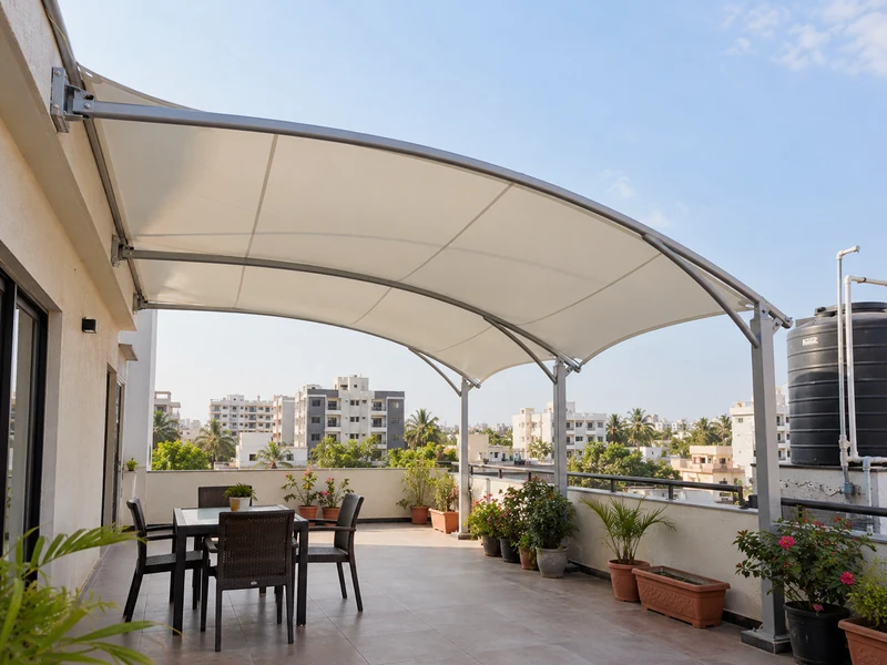 Wall-fixed membrane roof on a house terrace with potted plants and a water tank kept outside the cover