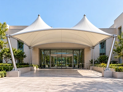 Architectural concept of a twin-peaked entrance canopy with a curved front beam and steel supports